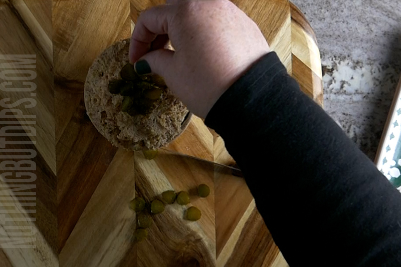 garnishing the smoke salami and cheese pate with diced Gherkin sweet pickles