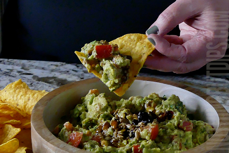Homemade Guacamole served on a tortilla chip