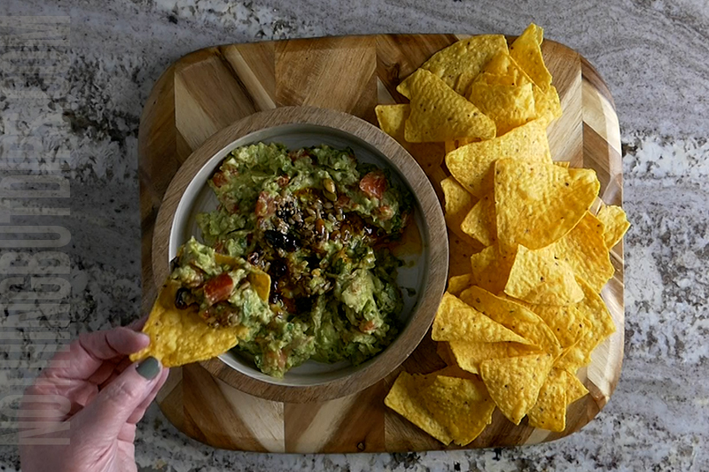 serving guacamole on a tortilla chip