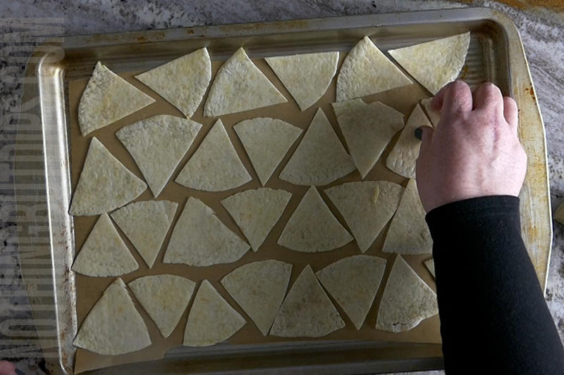 place the triangle tortilla chips onto a baking sheet