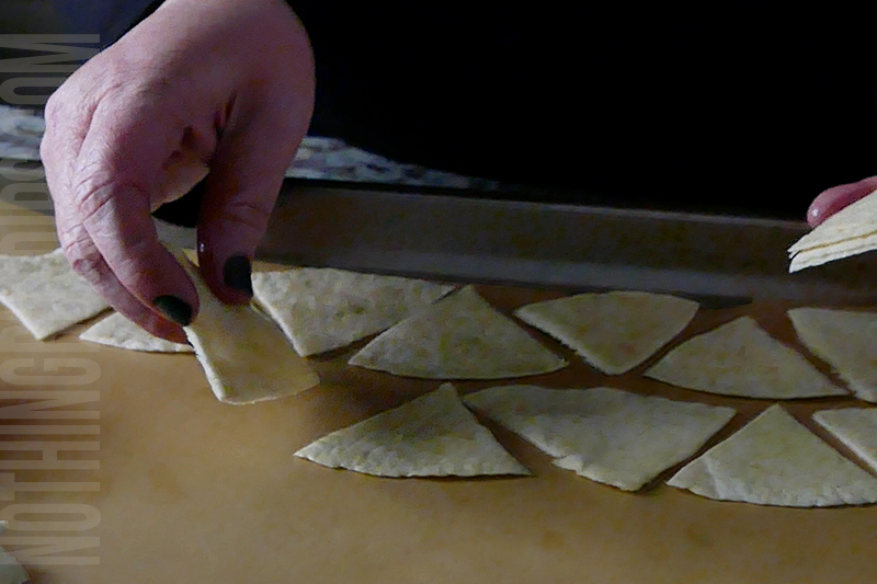 place the triangle tortilla chips onto a baking sheet