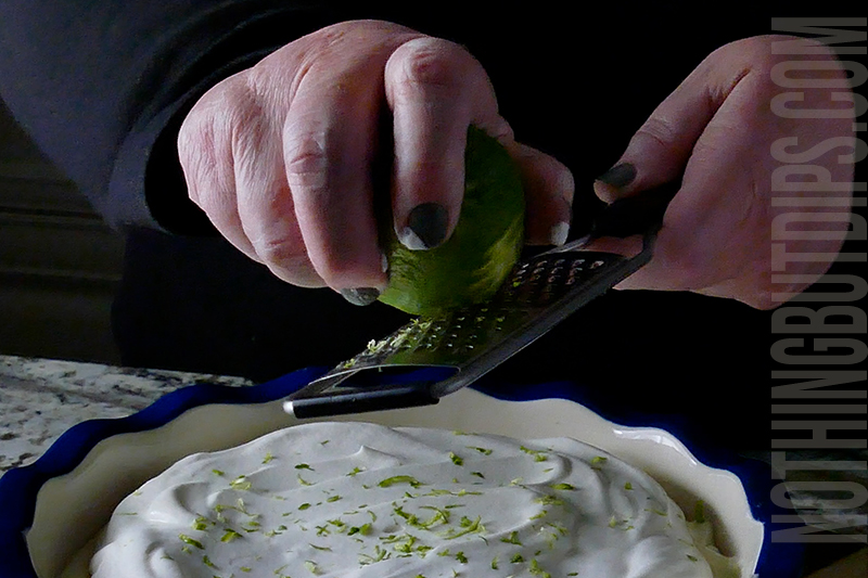adding some lime zest to the top of the key lime pie dip