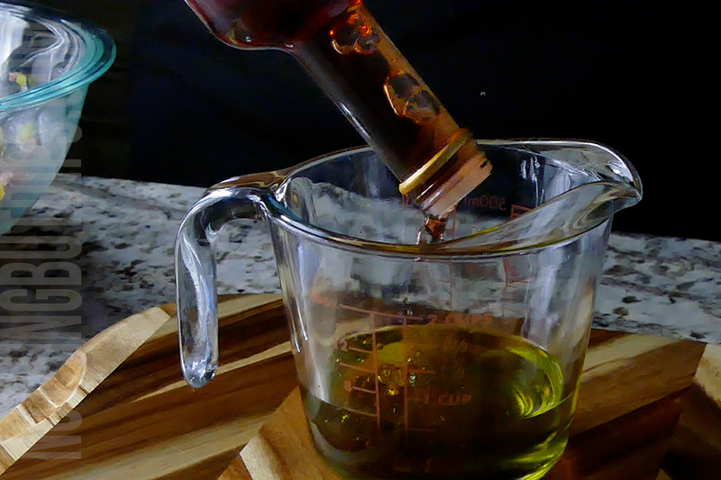 adding red wine vinegar to make vinaigrette dressing for Italian sub dip