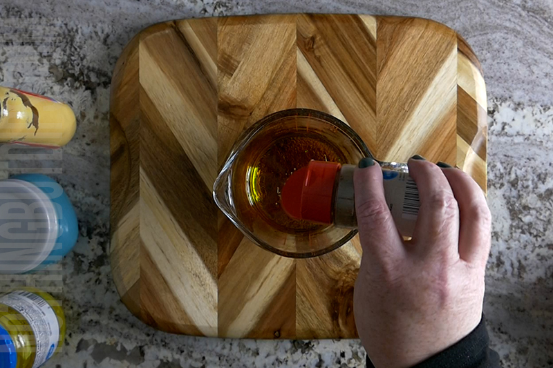 adding Italian seasoning to make vinaigrette dressing for Italian sub dip