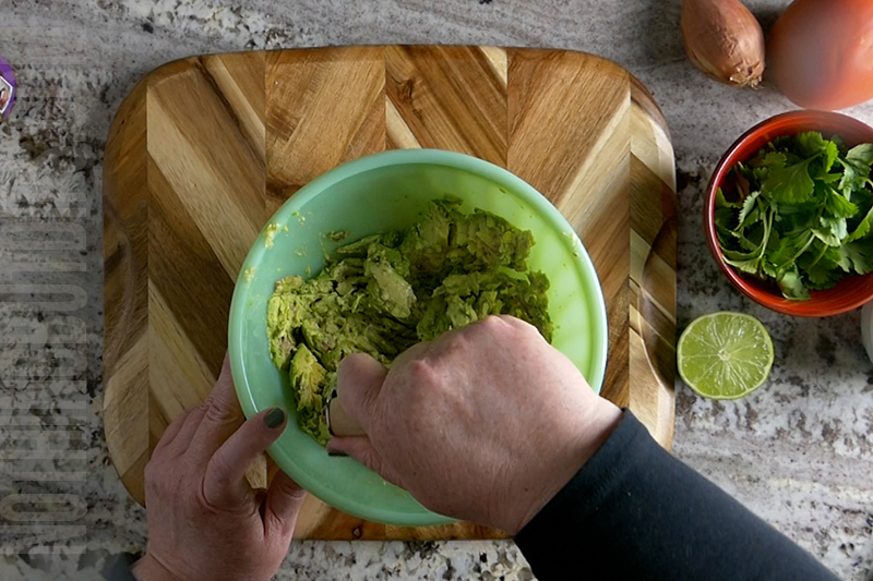 smashing avocados for guacamole
