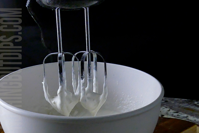 mixing the fresh whipped cream with a hand mixer