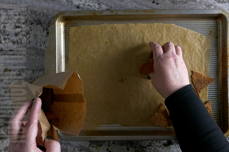 add the baked tortilla chips to the bag of cinnamon and sugar