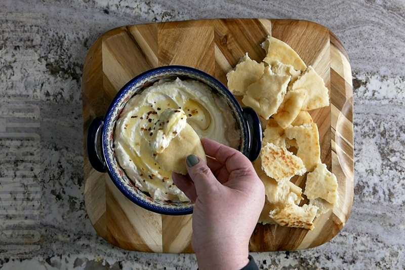 easy feta whip being served on a warm pita