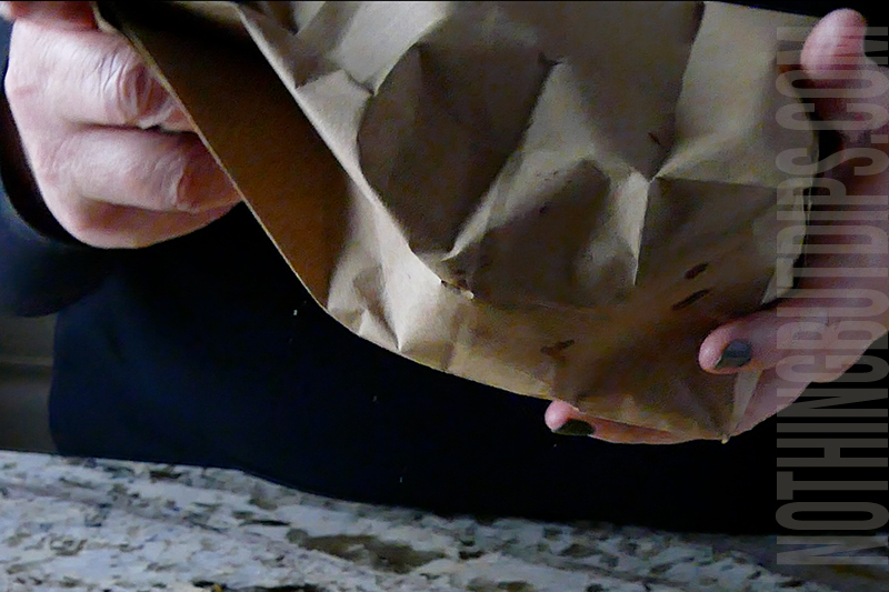 shaking the paper bag filled with donuts, sugar and cinnamon