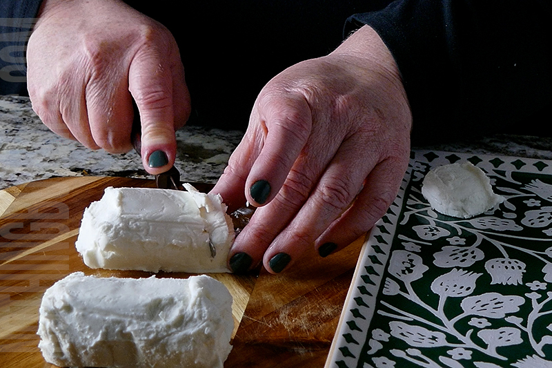 slicing the goat cheese