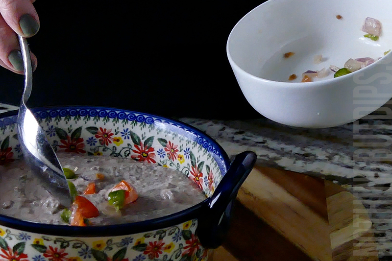 garnishing the black bean dip puree with pico de gallo