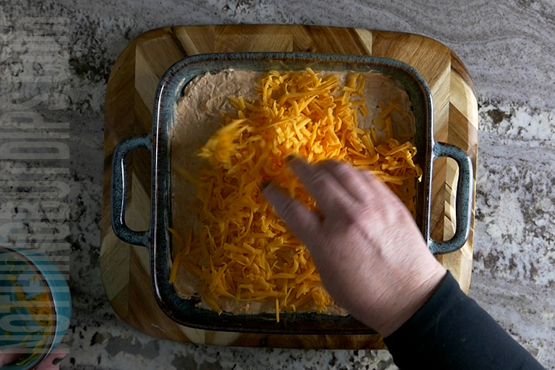 add shredded cheddar cheese to the bbq chicken dip