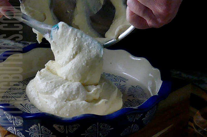 transferring the creamy base for the key lime pie dip to a serving dish