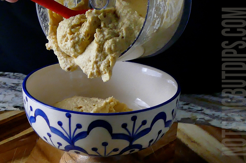 transferring the lemon garlic hummus to a serving dish