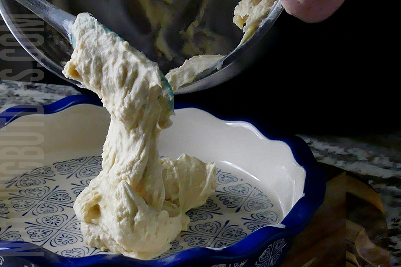 transferring the creamy base for strawberry basil cheesecake dip to the serving dish