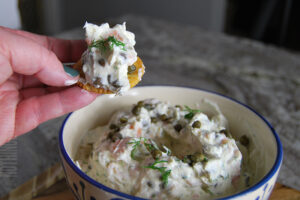 Simple smoked salmon and dill dip served on a cracker