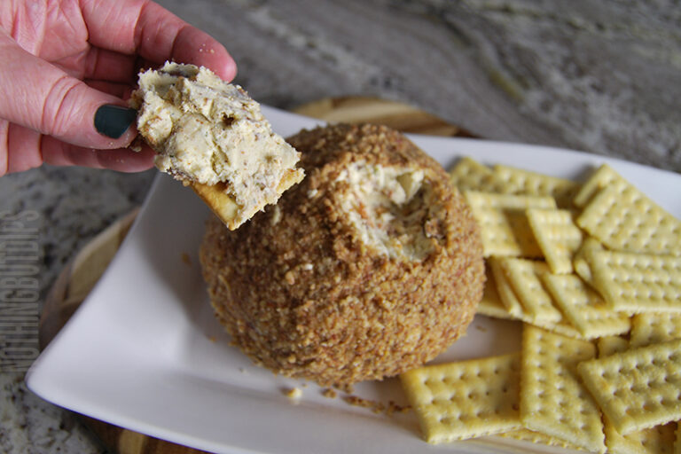 easy classic cheese ball served on a cracker