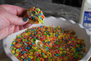 easy cereal and milk dip made with Fruity Pebbles served on a shortbread cookie