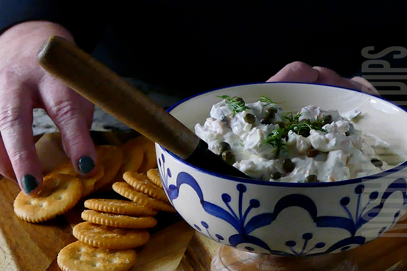 smoked salmon and dill dip in serving dish with crackers on side