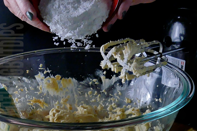 adding powdered sugar to the mixing bowl to make salted caramel dip