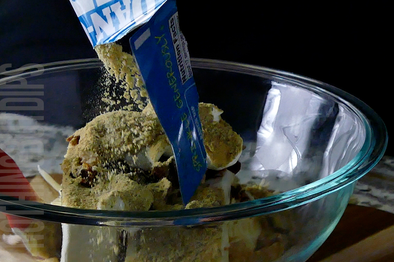adding ranch mix to a bowl to make a classic cheese ball