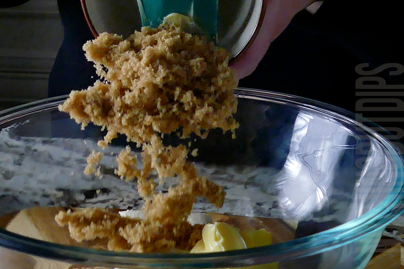 adding brown sugar to the mixing bowl