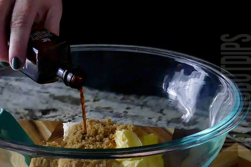 adding vanilla to the mixing bowl
