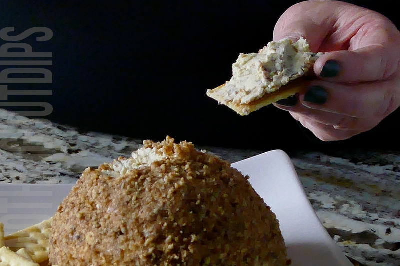 easy classic cheese ball served on a cracker