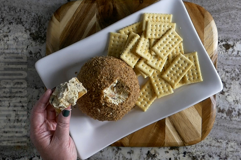 easy classic cheese ball served on a cracker