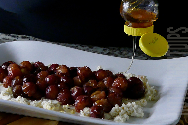drizzling honey on top of roasted grapes on top of Boursin cheese to make a delicious appetizer