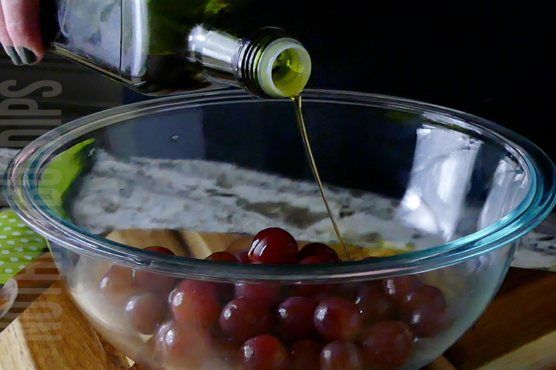 drizzling olive oil over grapes