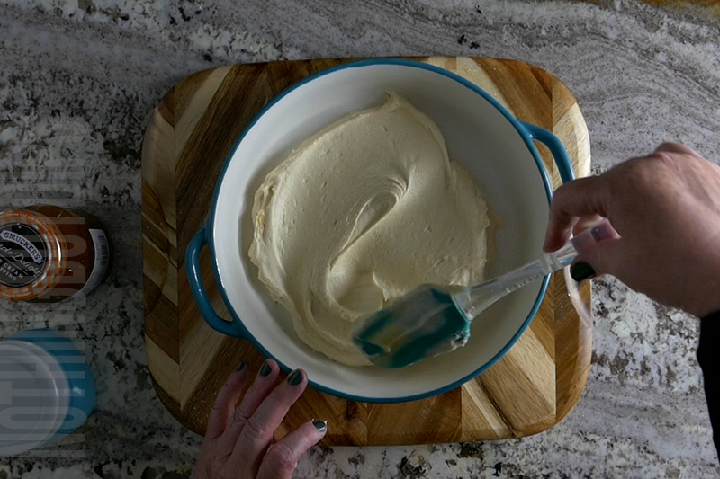 spreading out the creamy mixture for the base of the salted caramel dip in a pie plate