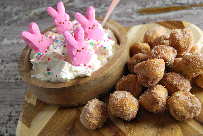 Easter dip with marshmallow bunny peeps on top and donut holes on the side 