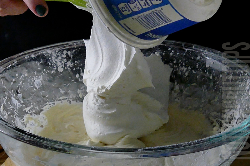 adding the whipped cream to the mixture to create birthday cake dip