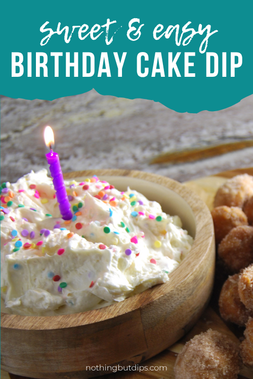 Easy sweet and creamy birthday cake dip with a birthday candle on top and donut holes on the side for serving