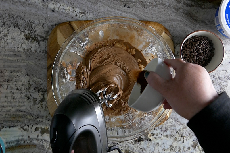 mixing the cream cheese, melted chocolate, espresso powder and powdered sugar to create the base for the chocolate espresso dip
