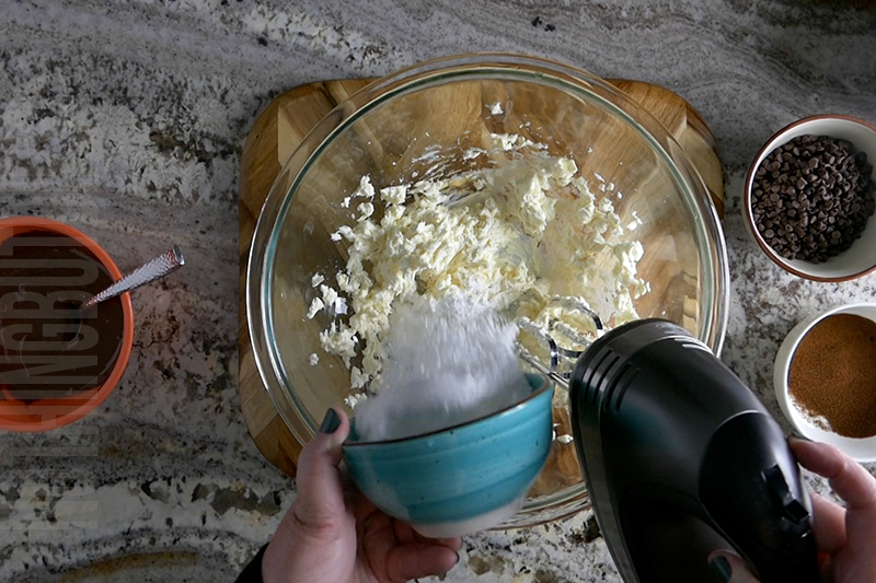 mixing the cream cheese and powdered sugar to create the base for the chocolate espresso dip