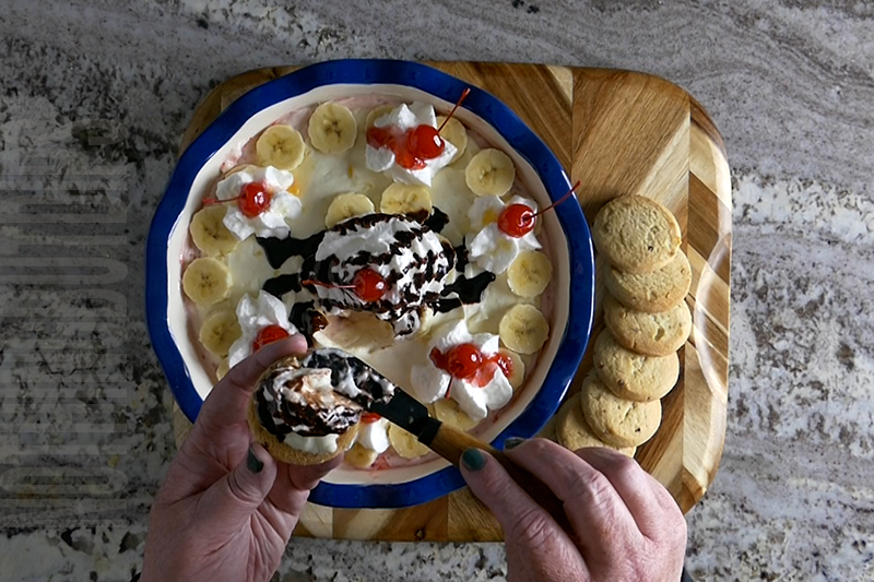 serving the banana split dessert dip on shortbread cookies