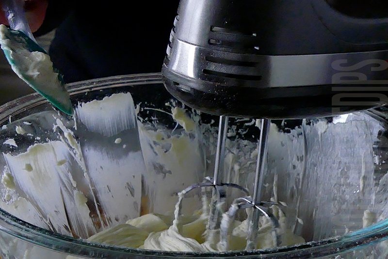 using a hand mixer to beat the cream for the banana split dip