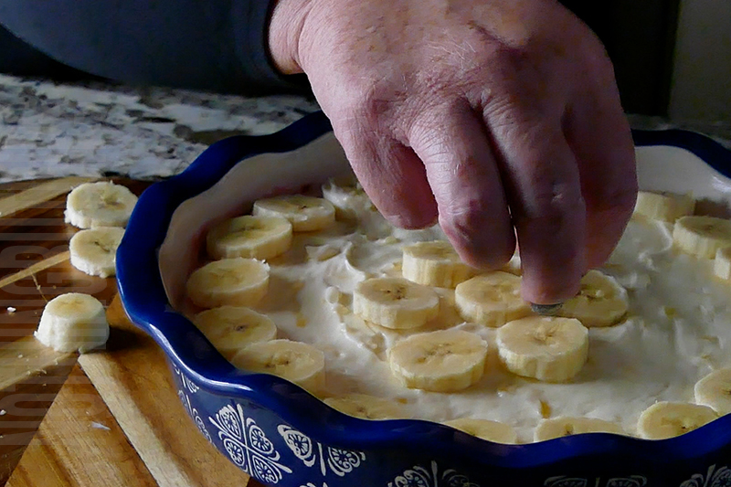 placing sliced bananas on top of the banana split dip