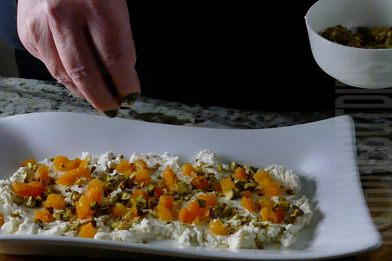 sprinkle crushed pistachios on top of Boursin cheese with dried apricots