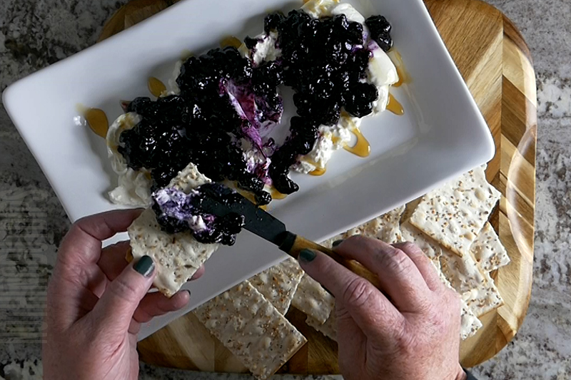 Tasty Burrata with Blueberries Appetizer Dip served on a cracker