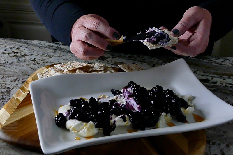 Tasty Burrata with Blueberries Appetizer Dip served on a cracker