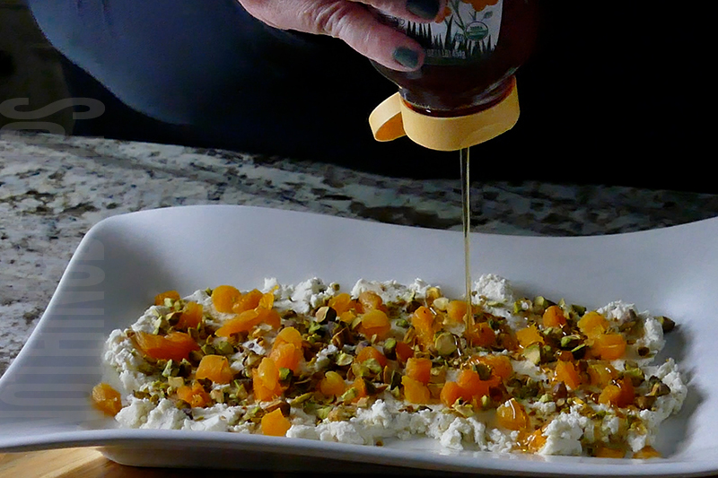 drizzle honey onto Boursin cheese with dried apricots and pistachios