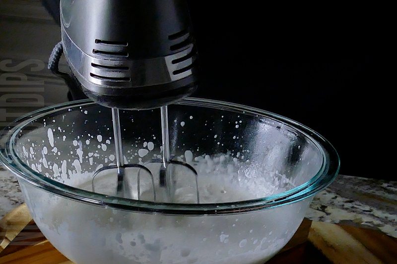 using a hand mixer to turn cream into whipped cream