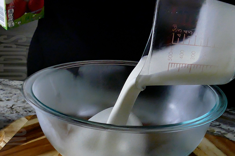 pouring whipping cream into a bour.
