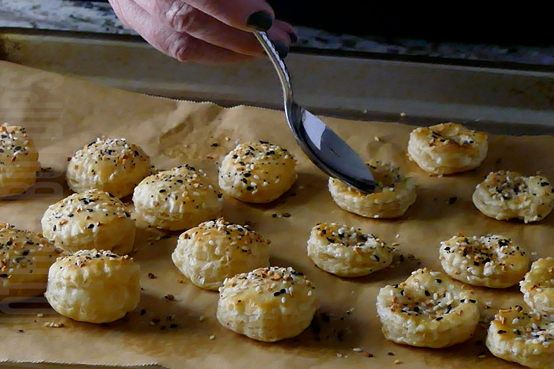 pressing down the center of the puff pastry rounds with a spoon