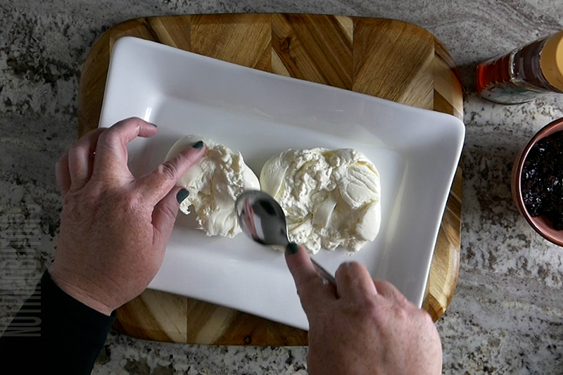 spreading blueberry compote on a serving platter