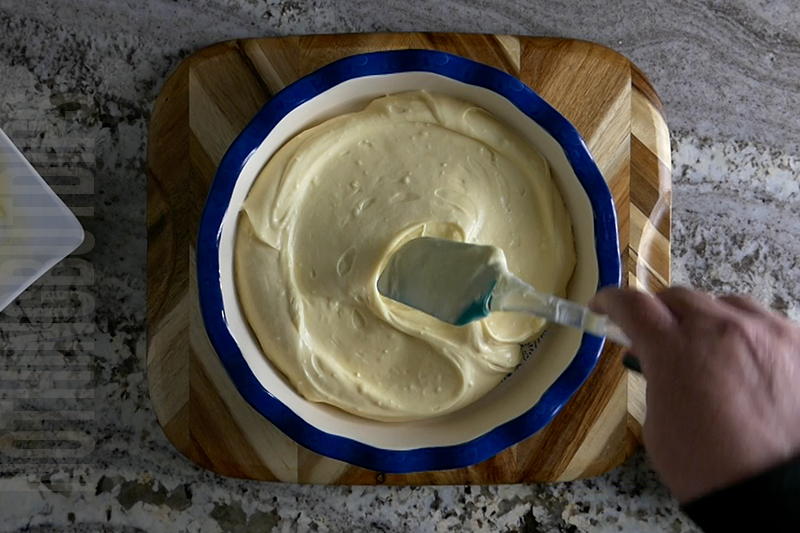 transferring the base of the tropical fruit dip dessert to a serving dish