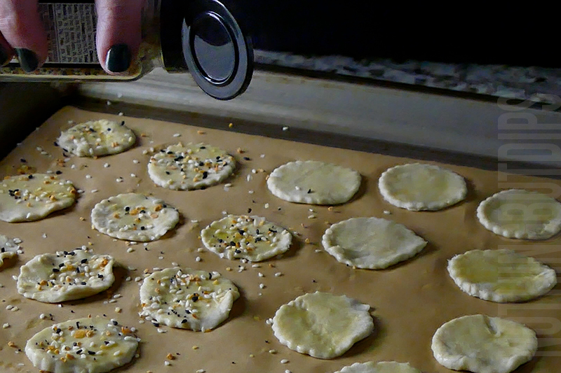 sprinkling the puff pastry pieces with everything bagel seasoning